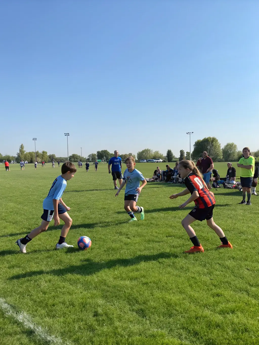 Teenage players from Football Club Saint Rominois are engaged in a competitive scrimmage, demonstrating advanced techniques and strategic play under the supervision of experienced coaches.
