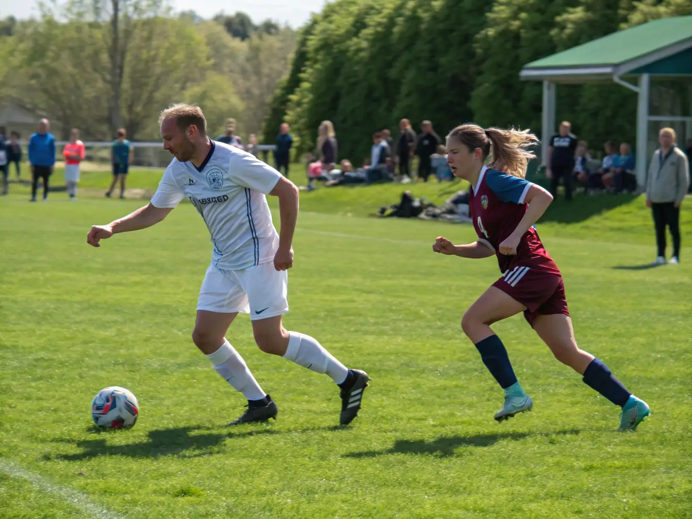 An image of adult players engaged in a competitive football match at FOOTBALL CLUB SAINT ROMINOIS, highlighting the intensity and camaraderie of the sport.